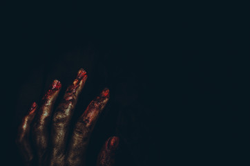 Bloody dirty zombie hand on black background. Halloween spooky poster