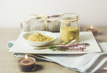 Ceramic tray with jar and bowl with mustard powder, towel and aroma candles to make foot bath. Against cold illness, congestion, aches and improves blood circulation.