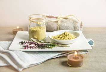 Ceramic tray with jar and bowl with mustard powder, towel and aroma candles to make foot bath. Against cold illness, congestion, aches and improves blood circulation.