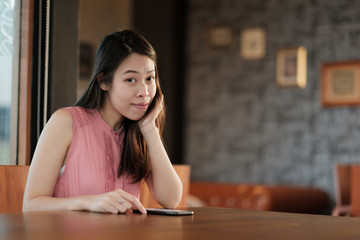 Young happy woman sitting modern office.