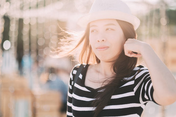 Woman traveler be smile with beautiful bokeh background,Holiday relaxation concept.