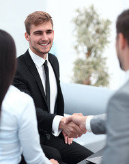 handshake business partners in the lobby of the office.