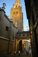 Toledo, Spain - September 24, 2018: Street of the Arch of Palace next to the tower of the Santa Iglesia Catedral Primada de Toledo.