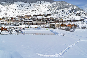 View of the village from an alpine skiing slope in winter day