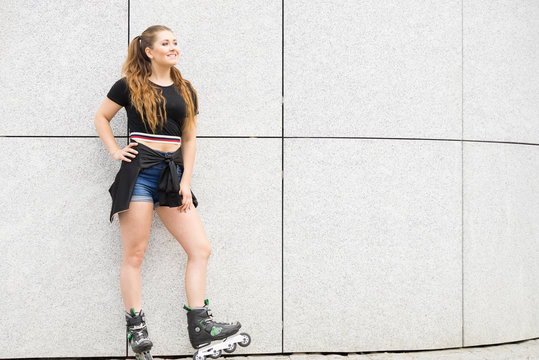 Young woman riding roller skates