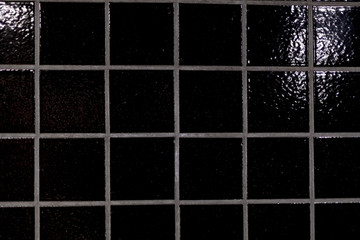 Black shiny tiles in closeup