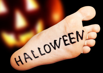 Foot with the inscription black Halloween collage on a black background.