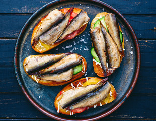 homemade sprat sandwiches with vegetables and mayonnaise top view