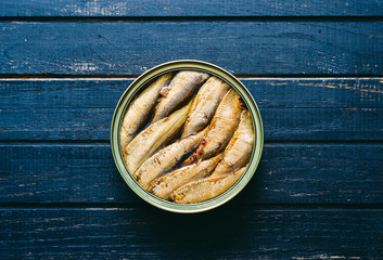 Baltic canned seafood fish sprats in a tin can with oil on a wooden table top view 