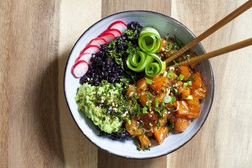 Hawaiian salmon poke with black rice, avocado, pickled cucumber and crispy kale
