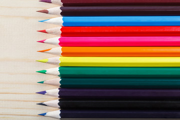 Colored pencils on wood background with space for your text