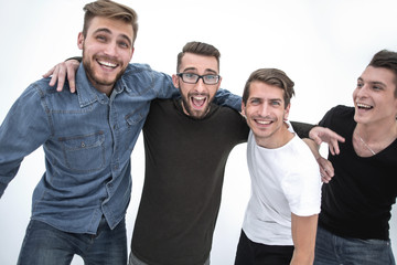 Four cheerful young guys stand and hug