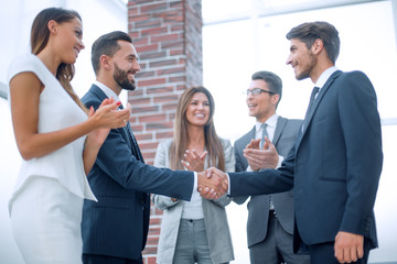 happy business team applauds new business partners