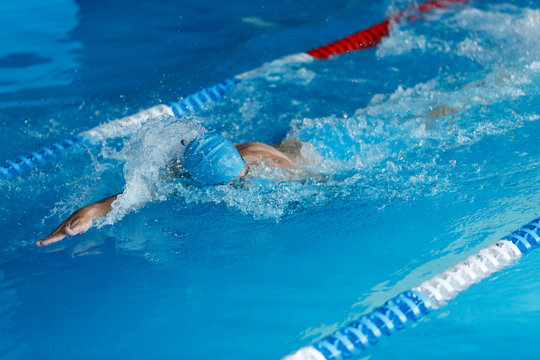 Image of sporty man swimming in style of crawl in swimming pool