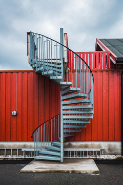 Winding staircase near red fence