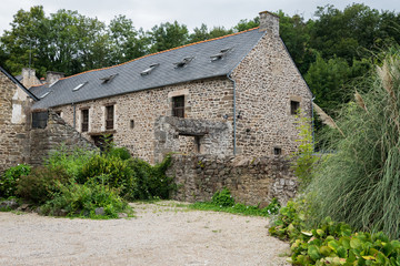 Fototapeta na wymiar Old stone house in Dinan on a cloudy day in summer