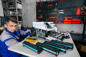 specialist repairman service or repairs the laser printer