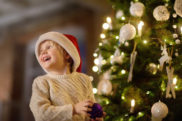 Cute little boy wearing Santa hat ready for celebrate Christmas