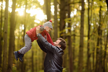 Little boy with his father during stroll in the forest