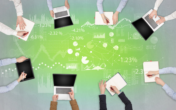 Group of people with devices in hands teamworking on laptops, tablets and prepare report with chart and graphs concept
