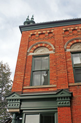 Fototapeta na wymiar Brick Facade with Arched Windows