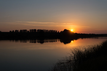 Obraz premium Sunset, silhouette, sound wave, Sound of sunset, a sound wave made by silhouette of trees and its reflection in the mirror of calm lake at a sunset