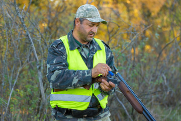 Hunter with a german drathaar and spaniel, pigeon hunting with dogs in reflective vests	