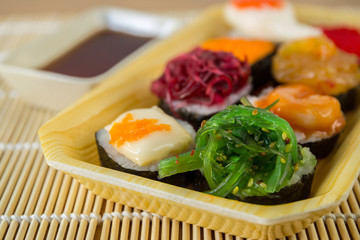 Sushi rolls served on a wooden plate