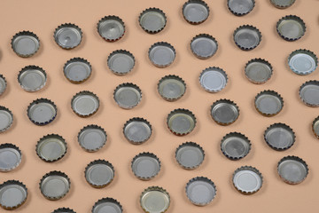 bottle caps lined up in color background