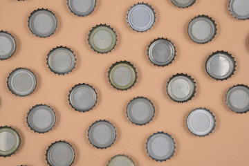 bottle caps lined up in color background.