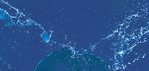 Splashes of water on a blue background. Blue background made of water, splash and drops