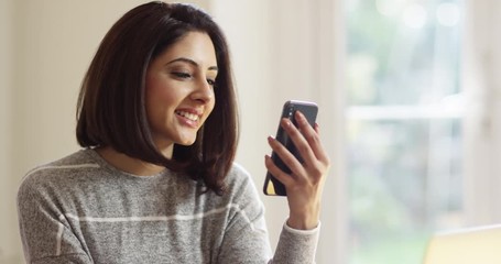 4K Young professional woman making face to face video call on her cell phone - Powered by Adobe