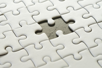 Incomplete, unfinished business strategy or finalize, problem solution metaphor, jigsaw puzzle with uncompleted missing piece