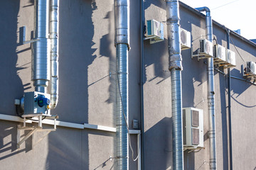 air conditioners and ventilation pipes on the wall