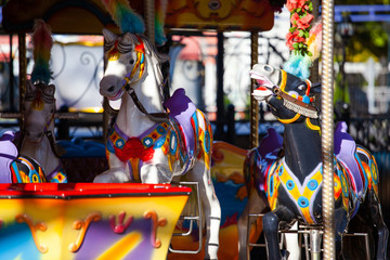 horses on a carousel in an amusement park