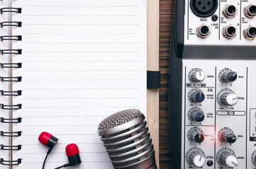 Audio recording studio concept. Karaoke. Song lyrics. Microphone, audio sound mixer, blank page...