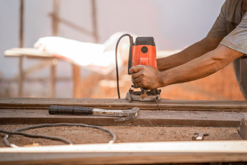 Man doing woodwork in carpentry. Carpenter work on wood plank in workshop