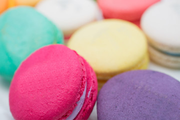 colorful magaroon is placed in a white ceramic dish. Elegant marble dining table with coffee table.