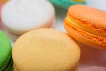 colorful magaroon is placed in a white ceramic dish. Elegant marble dining table with coffee table.