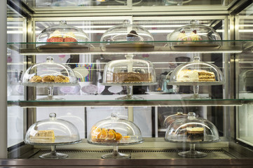 Pastries and cakes on showcase in the pastry shop.