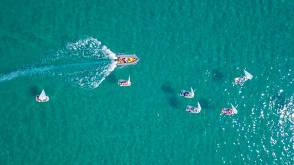 Group of small sail boats in the calm waters of a Mediterranean bay