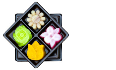 Large set of many shape and colorful traditional Thai style sweet dessert in black box arranged in rows. Made for natural ingredients in original native formula.