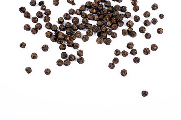 Black pepper corns on white background