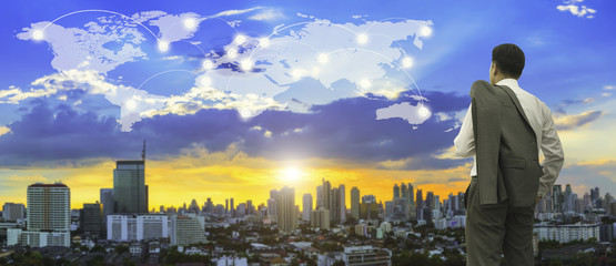 Business and modern connection technology concept. Businessman standing on roof top and looking...