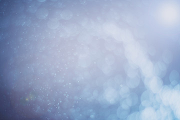 Blurred abstract bokeh light of fly water background, Christmas two tone colors.