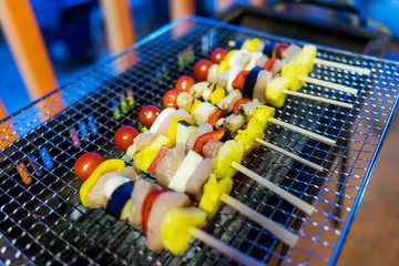 Home made barbecue (BBQ) with pork has a variety of fruits