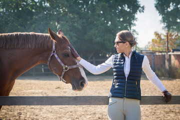 Woman strokes a horse
