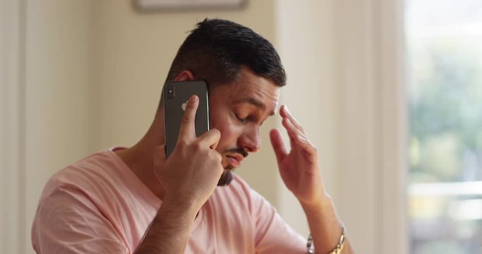 4K Stressed & worried Indian man being given bad news during phone call. Slow motion.