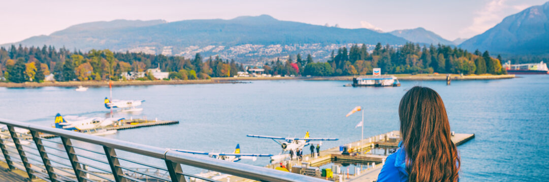 Woman walking in Coal Harbour in Vancouver city in fall, BC, Canada. Autumn travel lifestyle panorama banner.