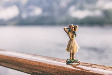 Hula dancer hawaii souvenir girl doll on cruise ship deck travel trip - funny vacation concept background. Autumn Alaska holiday.